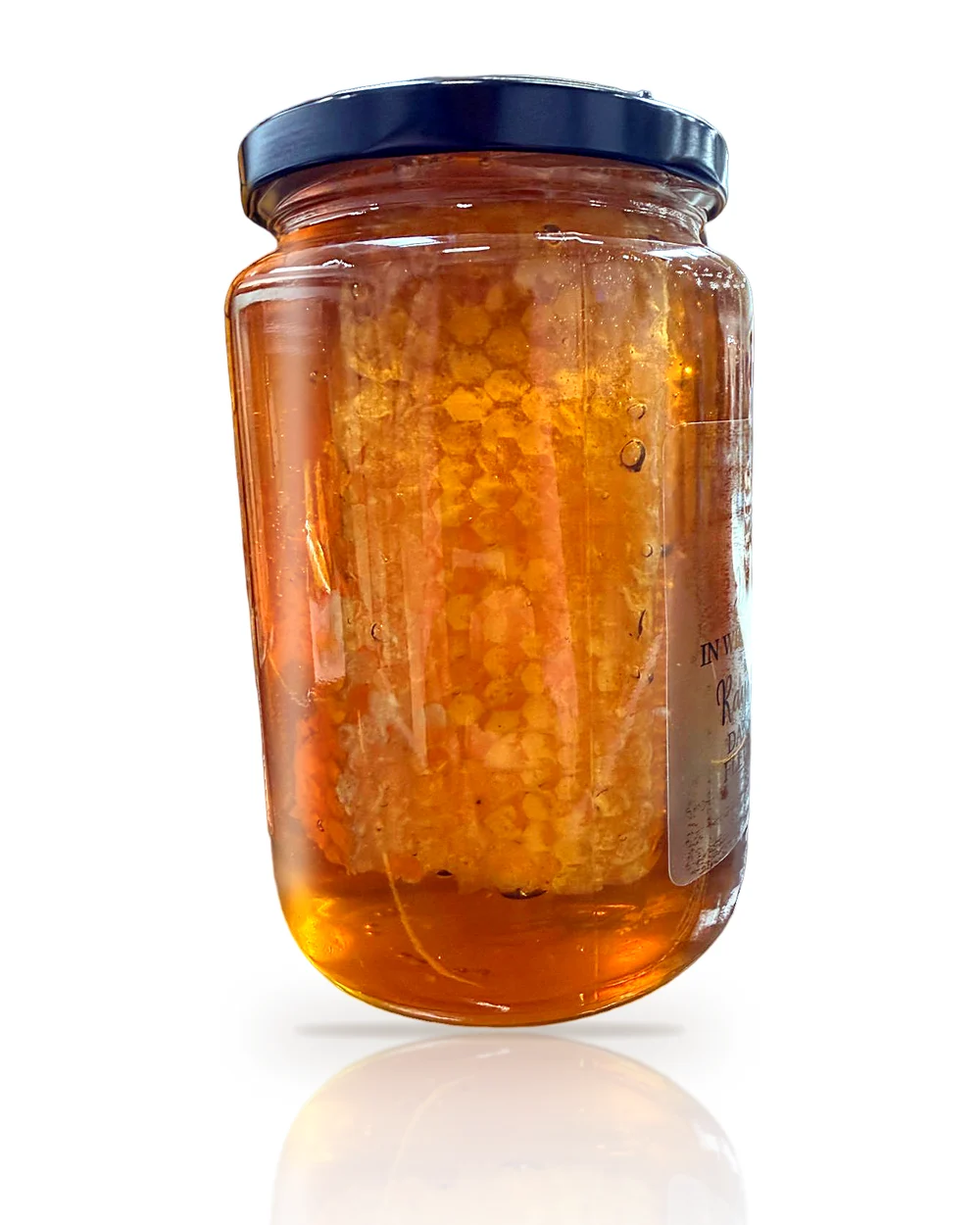 Close-up of natural honeycomb suspended in wildflower honey